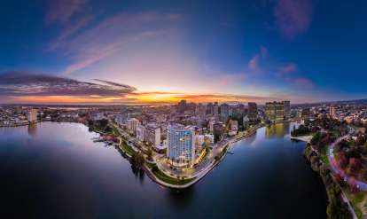Aerial shot of Lake Merritt with Downtown Oakland in the background during a sunset