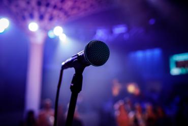 Microphone on a Stage with purple lighting.