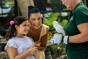 Mother and daughter meet Luna the luecistic screech owl at Peace River Wildlife Center