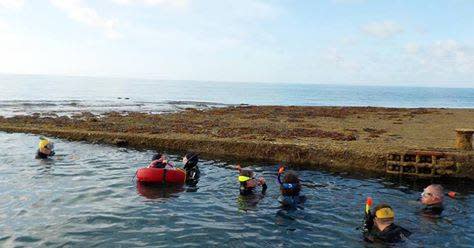 Divers alongside a Mulberry Harbour