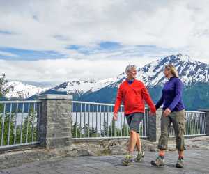 A couple walks at Bird Point along Turnagain Arm.