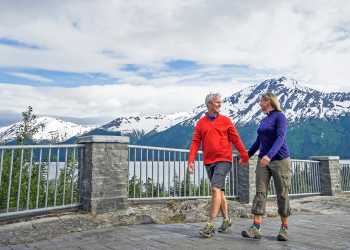 A couple walks at Bird Point along Turnagain Arm.