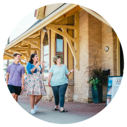 Three friends walking to the front door at the Station Arts Centre, an art centre in a repurposed historic train station