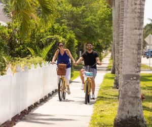 Two people enjoying a ride on free yellow loaner bikes in Punta Gorda/Englewood Beach