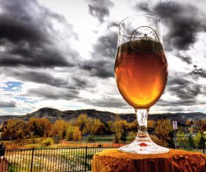 Beer glass with autumn mountain backdrop