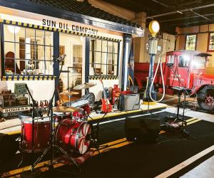 Exhibit at the Boyertown Museum featuring a red truck and drum set