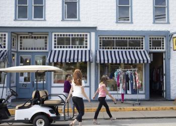 Visitors shopping in downtown Put-in-Bay near a golf cart
