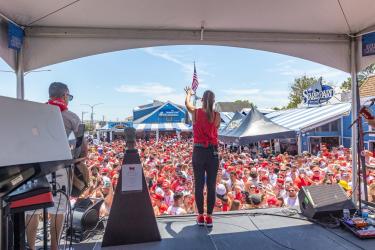 A crowd in front of a stage at Running of the Bull.
