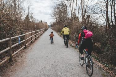 Family riding bikes on the Cross Kirkland Corridor