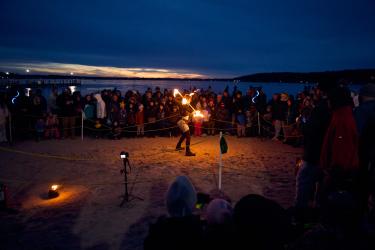 Fire artist on the beach during Winterfest 2025.