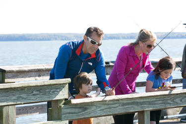 Family fishing on a dock at Leesylvania State Park