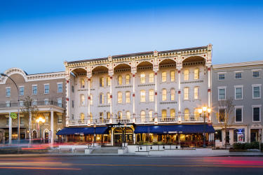 Adelphi Hotel at dusk with lights on