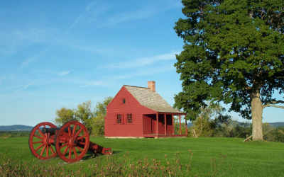 Red cabin and cannon on park grounds in the summer
