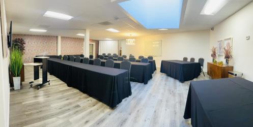 Lengthy black lined tables are set for a presentation viewing in the Executive Conference Room