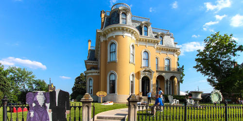 Exterior of the Culbertson Mansion with headless cutouts in front