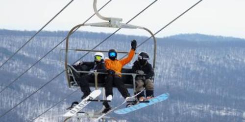 Three people in winter fear on a ski lift at Whitetail Resort