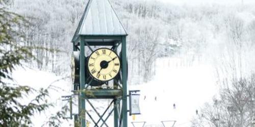 A clock tower on a snowy day at Hidden Valley Ski Resort