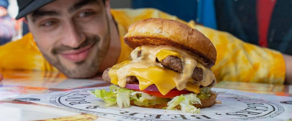 Man about to enjoy his lunch at S&B's Burger Joint in Automobile Alley