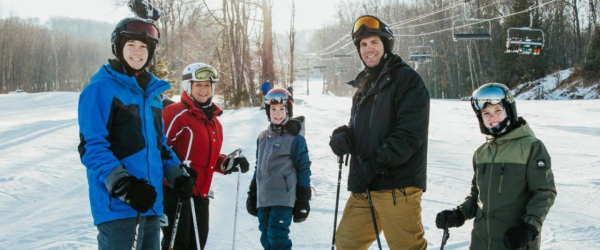 Family posing while skiing at Granite Peak