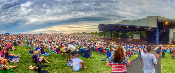 A group of people at an outdoor concert during the day