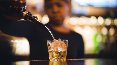 woman pours drink at Chattanooga Cigar Bar