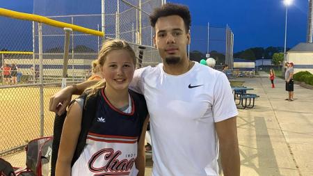 Jordan Peterson of Major Fit Training with one of his clients at her softball game. (Photo courtesy of Major Fit Training Facebook page)