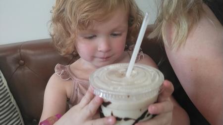 My daughter savoring a treat from Brown Skin Coffee
