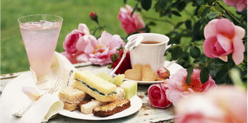 Tea sandwiches, biscuits, tea, and pink roses