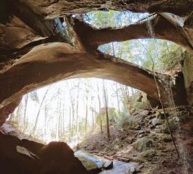 Natural bridge with a creek running under it.