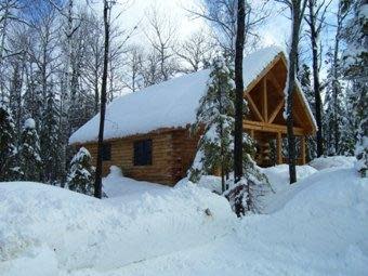 Snow covered log cabin