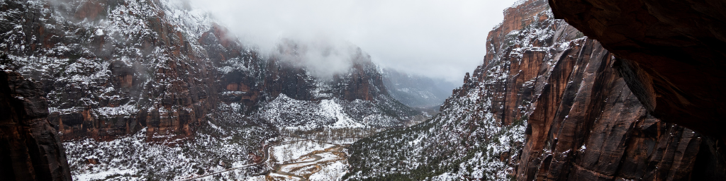Valley views of Zion National Park in winter framed by dark Navajo Sandstone rock formations.