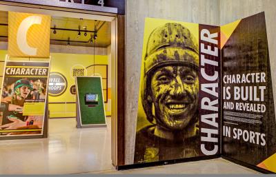 Bright yellow, black and white signage and large photos in the "Character" section of the "Ohio - Champion of Sports" exhibit at Ohio History Center