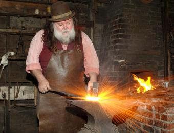A blacksmith hard at work in Old Cowtown