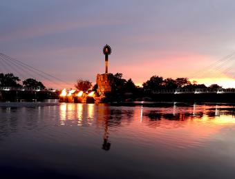 Keeper of the Plains at dusk with lit firepots