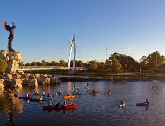 kayaks on the arkansas river near the keeper of the plains in wichita