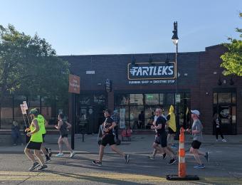 Prairie Fire half marathon runners passing in front of the shop.