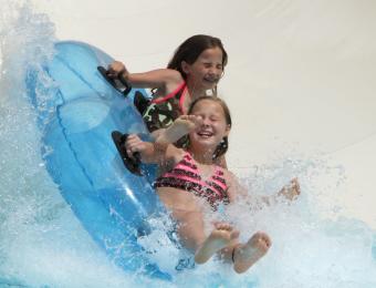 Two Girls Exiting a Waterslide at Rock River Rapids