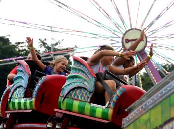 Midway rides with kids at Prince William County Fair