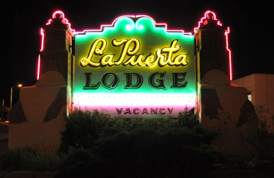 An image of the neon sign at La Puerta Lodge.