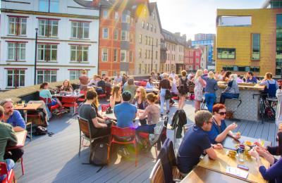 People sitting under the sun on the roof terrace at the Bambalan restaurant, central Bristol - credit Bambalan