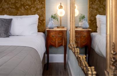 A bed and side table in Beech House - Credit Urban Apartments