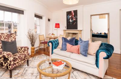 A room with 1 large armchair and a sofa - Credit Berkeley Suites