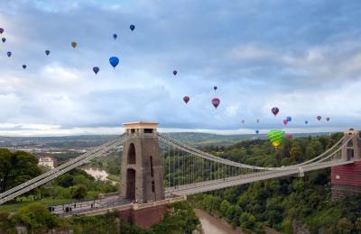 Balloons flying over the Clifton Suspension Bridge in West Bristol during one of the morning mass ascents from the Bristol Balloon Fiesta - credit Gary Newman