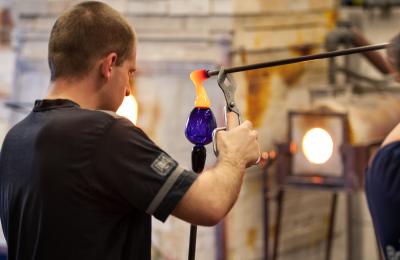 A staff member shaping a glass object at Bristol Blue Glass - credit Bristol Blue Glass
