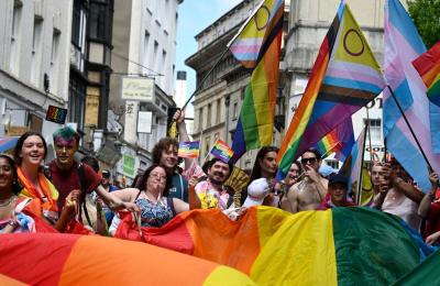 A group of people holding a large pride banner - Credit Bhagesh Sachania