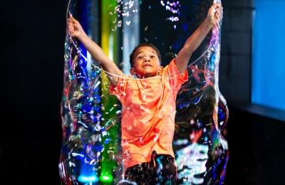 Boy playing  with giant bubble at We The Curious, Bristol - credit Lisa Whiting
