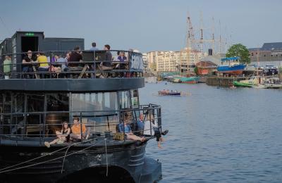 People sat on The Grain Barge in Bristol