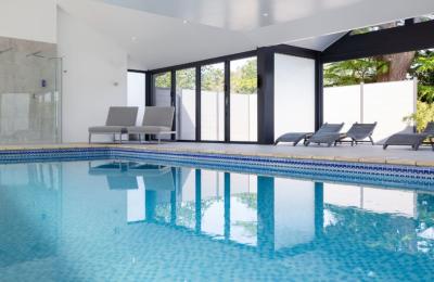 Indoor pool with loungers at Foxhills Spa - credit Old Down Estate