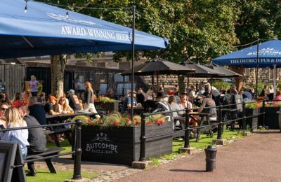 People sitting outdoors under the sun by The Ostrich pub in the Redcliffe area of Bristol - credit Mahtola Eagle