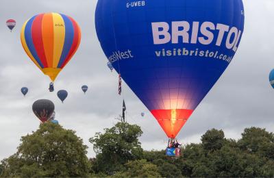 A group of balloons lifting off in a mass ascent at Bristol International Balloon Fiesta 2025